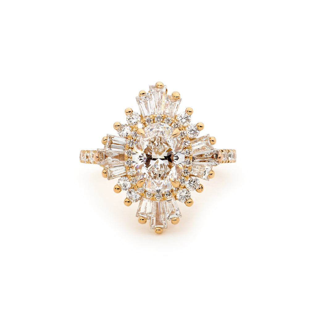 Gold ring with a central oval shaped diamond surrounded by smaller diamonds on a white background.