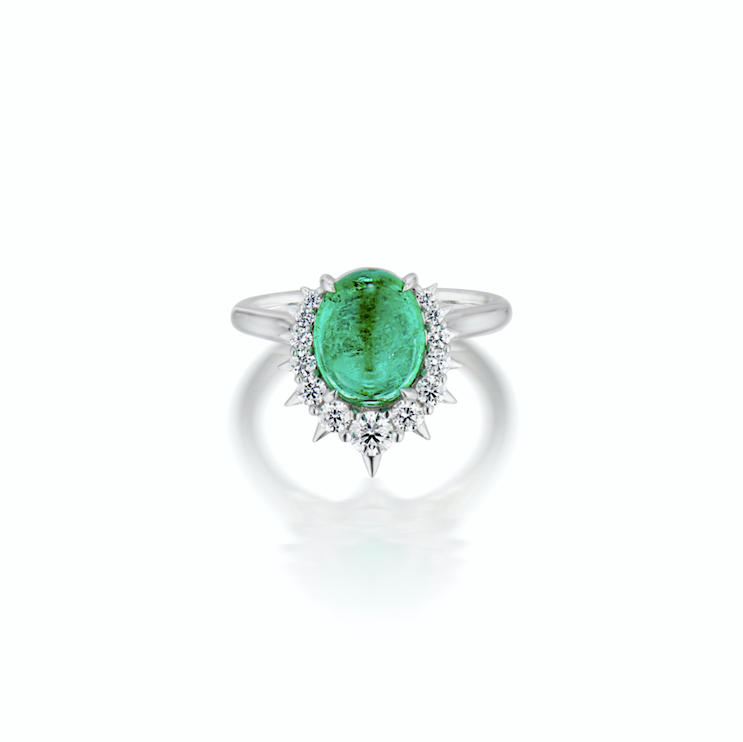 An elegant ring with a central oval emerald surrounded by sparkling diamonds, set in a white gold band.