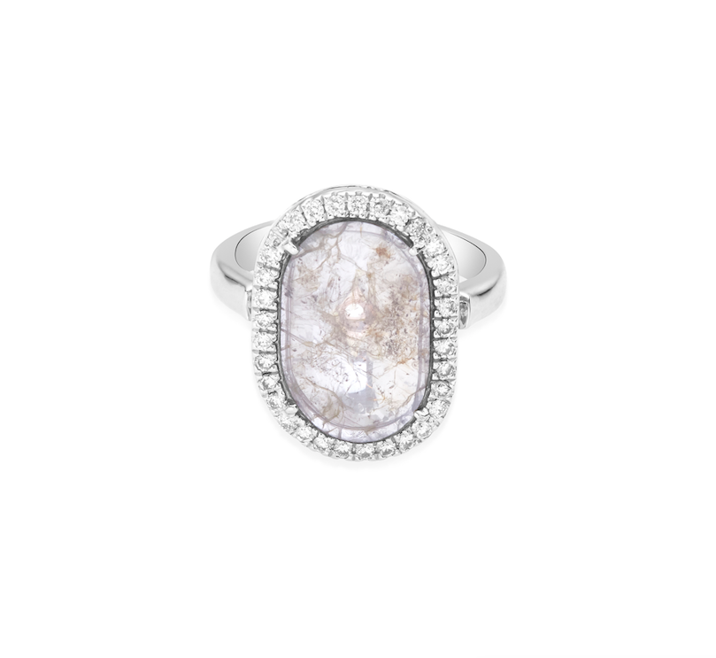 An oval-cut slice diamond ring with a halo of diamonds on a white gold  band.