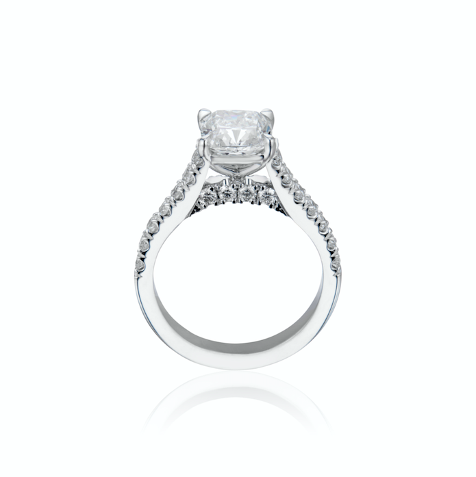 White gold engagement ring with a central diamond and side stones.