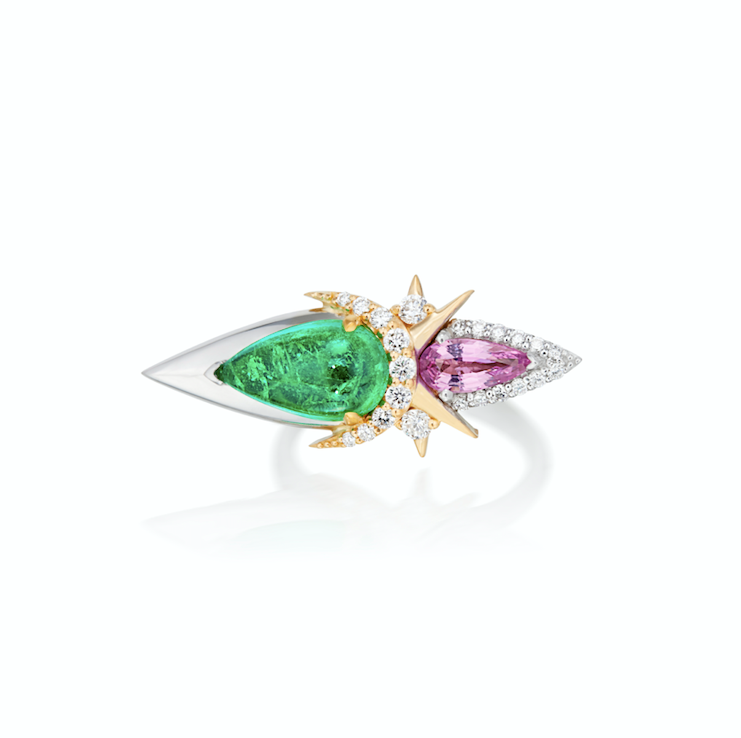 An elegant ring with a large green emerald, a pink sapphire, and diamond accents on a gold band.