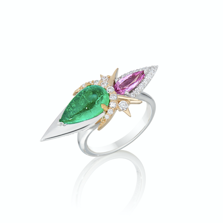 Ring with green emerald, pink sapphire gem, and diamond accents on a white background.