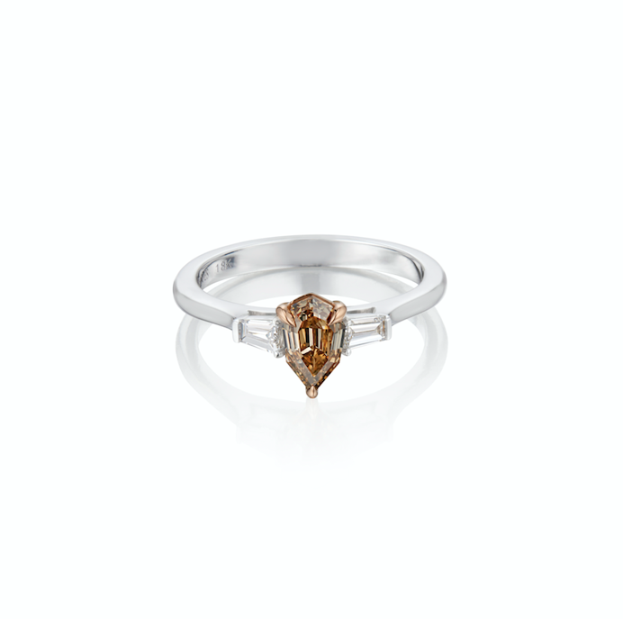 White gold ring with a pear-shaped champagne diamond flanked by two baguette-cut diamonds.