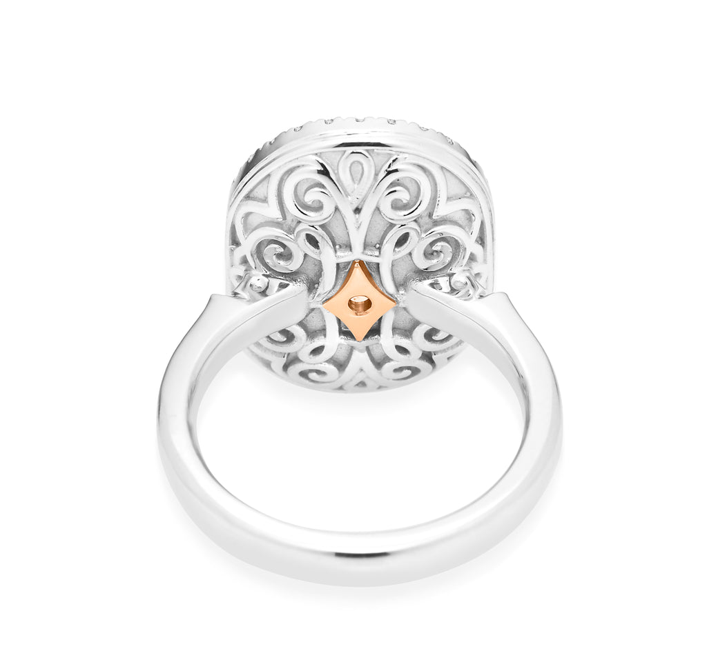 Back of white gold filigree ring with a small heart-shaped accent. 