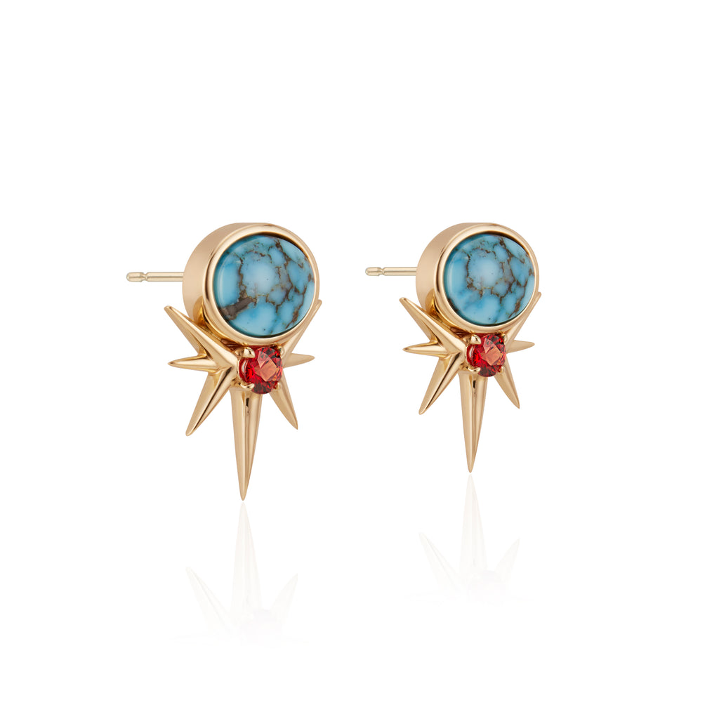 Gold starburst earrings with turquoise center and red stone detail.