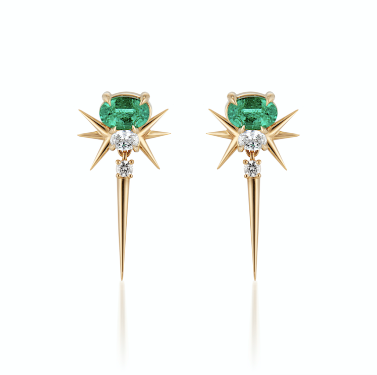 A pair of starburst earrings with green emerald gemstones and diamonds set in gold.