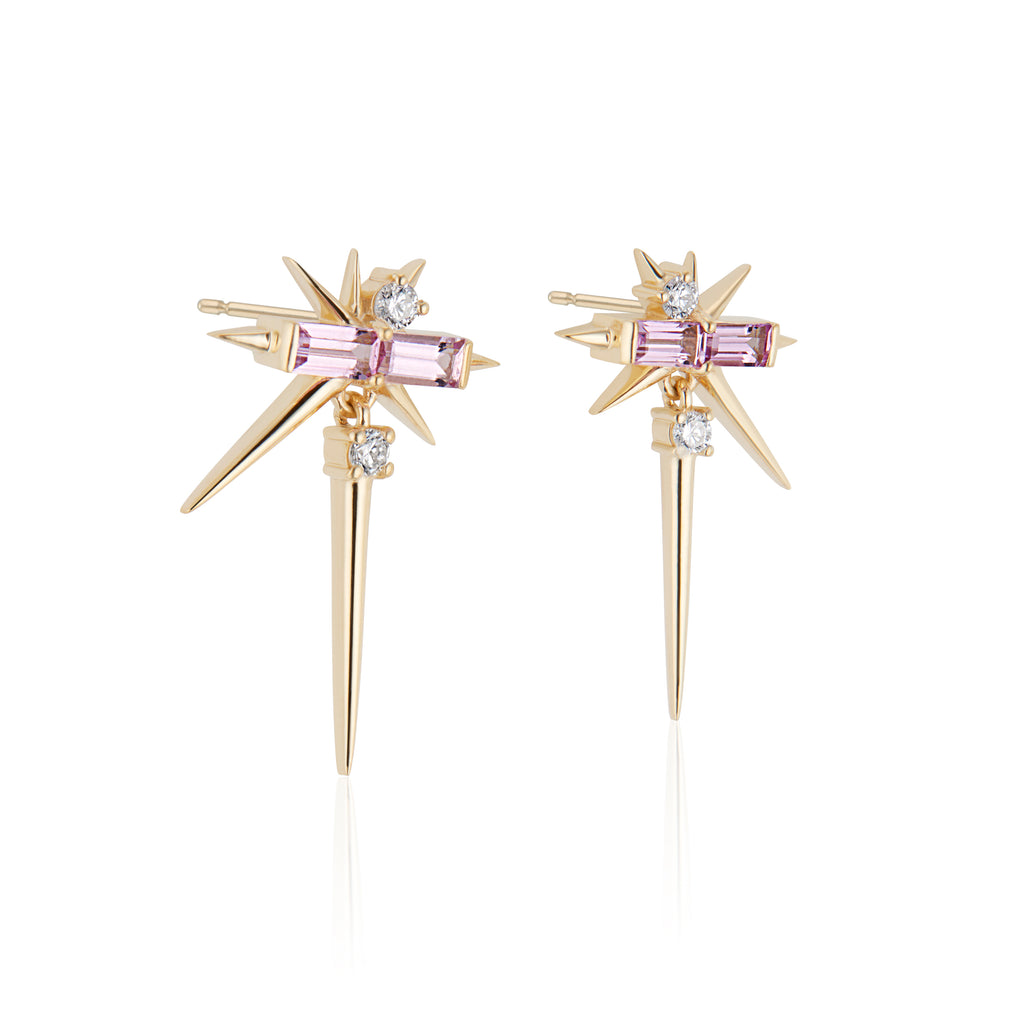 Gold starburst drop earrings with pink sapphires and diamonds on a white background.