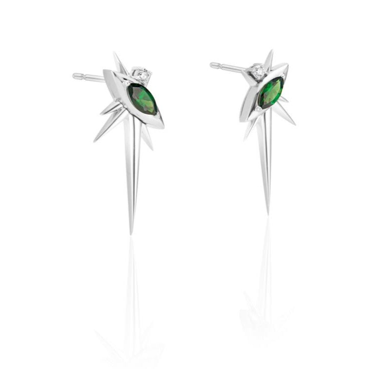 A pair of silver star-shaped earrings with green gemstones and diamond accents on a white background.